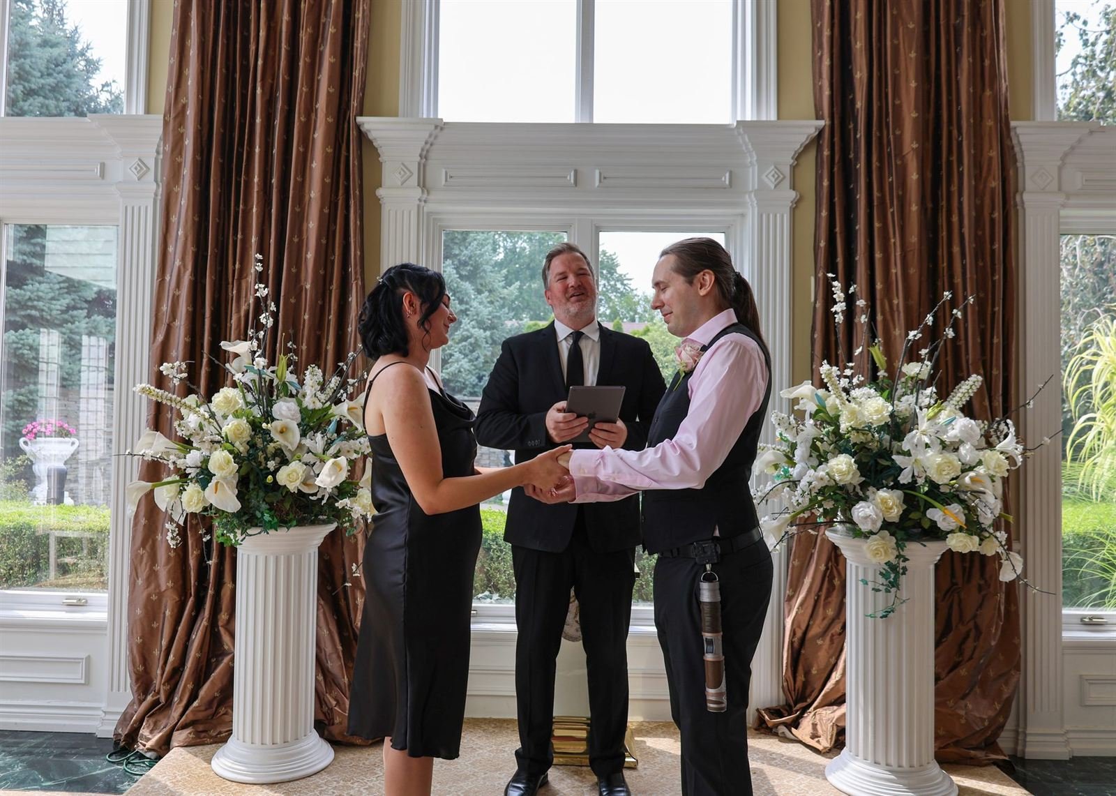 The vows — ceremony by tall windows