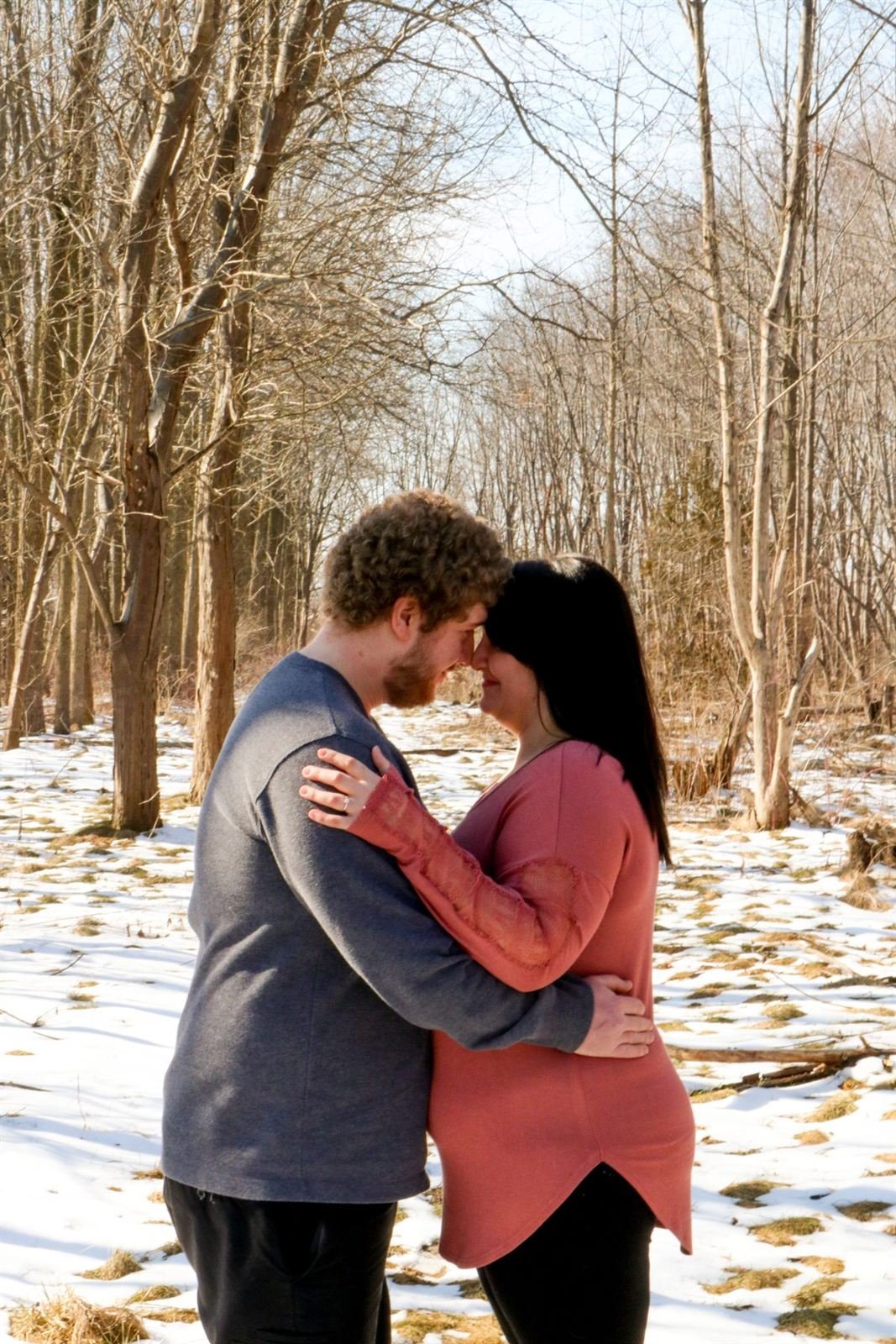 Couple embracing in a snowy forest